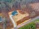 Angle shot showing the layout of a newly built house with a driveway and yard among bare trees at 596 Oaks Lane Rd, Timberlake, NC 27583