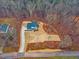 Aerial view of a newly built home with an extended driveway surrounded by trees at 596 Oaks Lane Rd, Timberlake, NC 27583