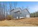 Exterior view of a two-story home showing a deck, an attached garage, and yard at 596 Oaks Lane Rd, Timberlake, NC 27583