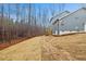 Backyard view of the home, showing the side of the house and the yard space at 596 Oaks Lane Rd, Timberlake, NC 27583