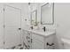 Modern bathroom with double vanity, sleek fixtures, patterned tile floors, and neutral decor at 596 Oaks Lane Rd, Timberlake, NC 27583