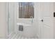 A modern bathroom showcases a sleek, standalone tub beneath a large window at 596 Oaks Lane Rd, Timberlake, NC 27583