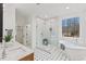 Bright bathroom featuring a soaking tub, a glass-enclosed shower, and double vanity at 596 Oaks Lane Rd, Timberlake, NC 27583