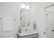 Modern powder room featuring a gray vanity, and decorative mirror at 596 Oaks Lane Rd, Timberlake, NC 27583