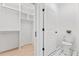 Bright bathroom features built-in shelving and walk-in closet adjacent to a toilet with patterned floors at 596 Oaks Lane Rd, Timberlake, NC 27583