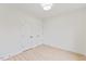 Neutral bedroom with hardwood floors and white walls, featuring two doors with black hardware at 596 Oaks Lane Rd, Timberlake, NC 27583