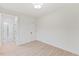 A bright bedroom featuring light wood floors, white walls, and a view into the bathroom at 596 Oaks Lane Rd, Timberlake, NC 27583