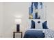A serene bedroom featuring a plush bed with blue accents and stylish artwork at 596 Oaks Lane Rd, Timberlake, NC 27583