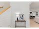 Bright entryway featuring a console table with decor, shiplap walls, and a view into the dining and living areas at 596 Oaks Lane Rd, Timberlake, NC 27583