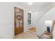 Inviting foyer showcasing a wooden front door, staircase, and a side table with elegant decorations at 596 Oaks Lane Rd, Timberlake, NC 27583