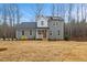 Charming two-story home featuring gray siding, black roof, and a cozy front porch with white railings at 596 Oaks Lane Rd, Timberlake, NC 27583