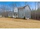 Charming two-story home featuring gray siding, black roof, and a cozy front porch with white railings at 596 Oaks Lane Rd, Timberlake, NC 27583