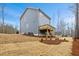 View of the rear exterior with a wood deck and newly seeded lawn at 596 Oaks Lane Rd, Timberlake, NC 27583