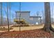 Back exterior featuring a deck with stairs, landscaping, and the siding of the house at 596 Oaks Lane Rd, Timberlake, NC 27583