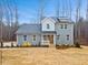 Charming two-story home featuring gray siding, black roof, and a cozy front porch with white railings and lawn at 596 Oaks Lane Rd, Timberlake, NC 27583