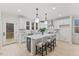 Open concept kitchen with island and white cabinets, complete with stainless steel appliances and hardwood floors at 596 Oaks Lane Rd, Timberlake, NC 27583