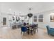Modern kitchen with island seating, stainless steel appliances, and a view of the dining area at 596 Oaks Lane Rd, Timberlake, NC 27583