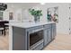 Kitchen island with a built-in microwave and grey cabinets with view to the main living space at 596 Oaks Lane Rd, Timberlake, NC 27583