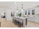 Bright kitchen featuring a large island, modern pendant lighting, white cabinetry, and stainless steel appliances at 596 Oaks Lane Rd, Timberlake, NC 27583