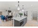 Open concept kitchen island with seating and stylish pendant lights overlooking dining and living spaces at 596 Oaks Lane Rd, Timberlake, NC 27583