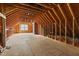 Unfinished attic space with exposed beams and a window at 608 Elin Ct, Hillsborough, NC 27278