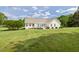 Well-maintained backyard with green lawn and a white two-story home at 608 Elin Ct, Hillsborough, NC 27278