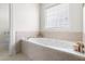 Bathroom features a soaking tub with jacuzzi jets and tile surround at 608 Elin Ct, Hillsborough, NC 27278