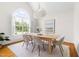 Elegant dining room featuring a large window, modern decor, and seating for six at 608 Elin Ct, Hillsborough, NC 27278
