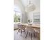 Light and airy dining room with a large window and a modern light fixture at 608 Elin Ct, Hillsborough, NC 27278