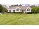 Charming single-story home with manicured lawn and inviting front porch, perfect for relaxing and enjoying the outdoors at 608 Elin Ct, Hillsborough, NC 27278