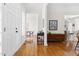 Inviting foyer with hardwood floors, elegant console table, and views into the dining and living spaces at 608 Elin Ct, Hillsborough, NC 27278