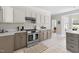 Spacious kitchen with tile flooring, stainless steel appliances, and stone countertops at 608 Elin Ct, Hillsborough, NC 27278