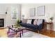 Comfortable living area with modern sofa, accent tables, and natural light, perfect for relaxing and entertaining at 608 Elin Ct, Hillsborough, NC 27278