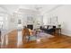 Spacious living room featuring a cozy fireplace, stylish furniture, and a tray ceiling that creates a bright, open atmosphere at 608 Elin Ct, Hillsborough, NC 27278