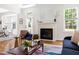 Cozy living room with fireplace, natural light, and seamless flow into the dining area for easy entertaining at 608 Elin Ct, Hillsborough, NC 27278