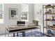 Close up of bright office with large windows, desk, rug and stylish bookshelf at 608 Elin Ct, Hillsborough, NC 27278