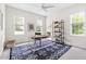 Bright office space with large windows, desk, rug and stylish bookshelf at 608 Elin Ct, Hillsborough, NC 27278