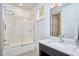 Clean bathroom with a tub-shower combo, tiled walls, modern fixtures, and a vanity with countertop at 631 Linfield Dr, Durham, NC 27701