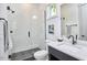 Modern bathroom featuring a glass shower, hex tile floor, and a stylish vanity at 631 Linfield Dr, Durham, NC 27701