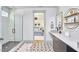 Bright bathroom featuring a glass-enclosed shower, patterned tile floor, and stylish vanity with modern fixtures at 631 Linfield Dr, Durham, NC 27701
