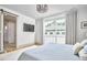 Sunlit bedroom featuring a large window with access to a balcony and an ensuite bath at 631 Linfield Dr, Durham, NC 27701