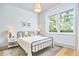 Bright bedroom with hardwood floors, neutral decor, and large windows at 631 Linfield Dr, Durham, NC 27701