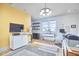 Bright room featuring modern lighting, light wood flooring, and large windows at 631 Linfield Dr, Durham, NC 27701
