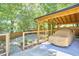 Carport in backyard has wood beams and is accessible by a wooden fence at 631 Linfield Dr, Durham, NC 27701