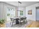 Elegant dining room with modern light fixture, large windows, and stylish decor at 631 Linfield Dr, Durham, NC 27701