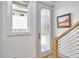 Bright entryway featuring a frosted glass door, side window, and modern artwork at 631 Linfield Dr, Durham, NC 27701