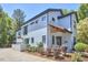 This renovated two-story home has white painted brick, black trim, and attached garage at 631 Linfield Dr, Durham, NC 27701