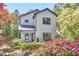 Charming two-story home with landscaped yard, featuring white brick, black trim, and covered entry at 631 Linfield Dr, Durham, NC 27701