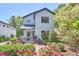Charming home with a manicured front yard featuring a variety of colorful flowers and lush greenery at 631 Linfield Dr, Durham, NC 27701