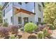 The covered front porch has a seating area and is surrounded by attractive landscaping at 631 Linfield Dr, Durham, NC 27701